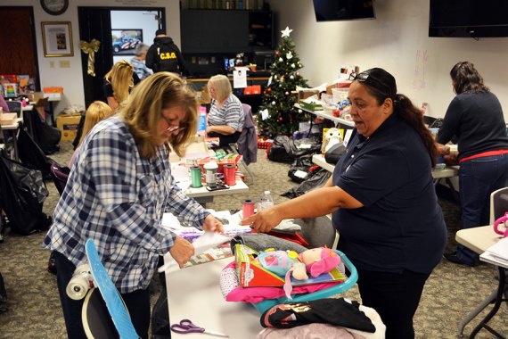 Terri Stephens and Soledad Perez are volunteering, keeping busy gift wrapping presents for the Lemoore Police Department's annual "Reasons for the Seasons" scheduled for Dec. 19 at 4 p.m. in the Lemoore Civic Auditorium.